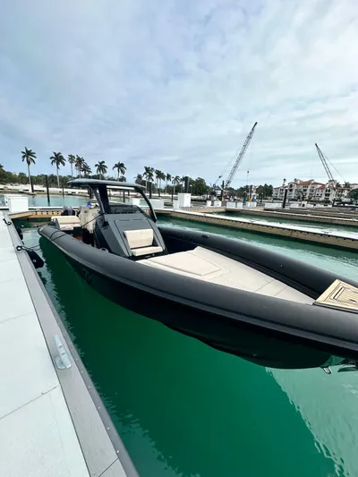 2024 Skipper 38 500r Yacht Photos Pics 2024 Skipper-BSK 38 boat docked in marina with palm trees and cranes in background.