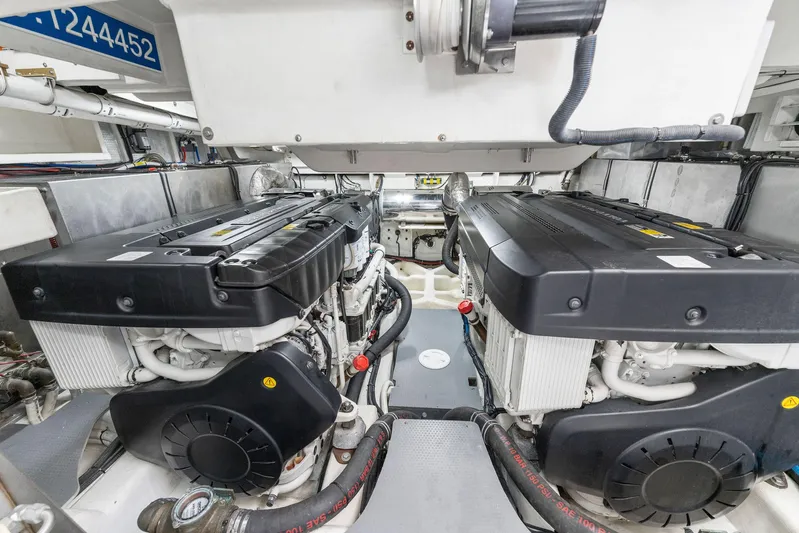 Blue Daksa Yacht Photos Pics Engine room of a 2013 Absolute 64 yacht, featuring dual engines and mechanical components.