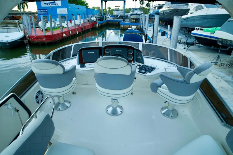  Yacht Photos Pics 2006 Sea Ray 44 Sedan Bridge helm with three seats, docked at marina.