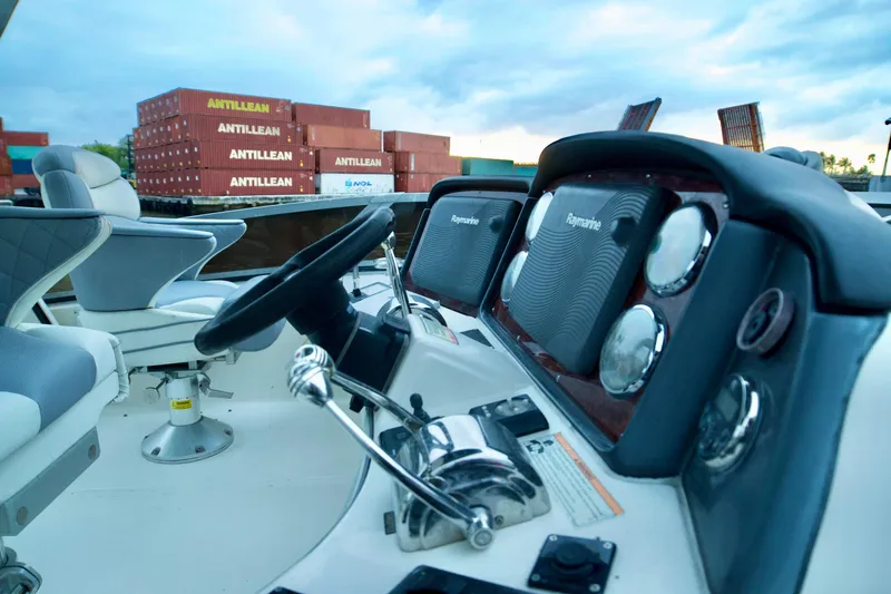  Yacht Photos Pics Helm of 2006 Sea Ray 44 Sedan Bridge with shipping containers in background.