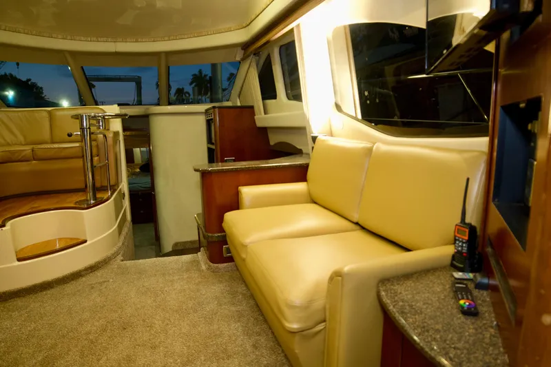  Yacht Photos Pics Luxurious interior of 2006 Sea Ray 44 Sedan Bridge yacht with beige seating.
