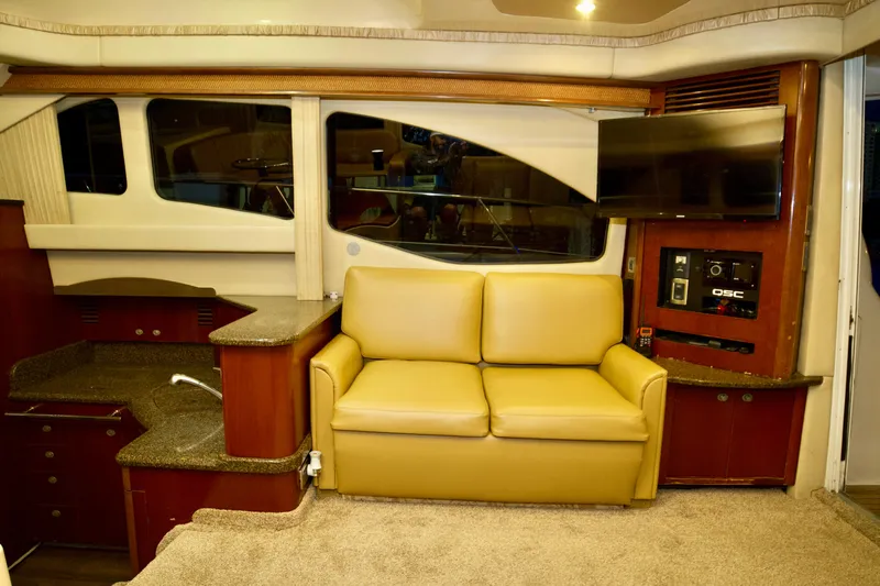  Yacht Photos Pics Interior of 2006 Sea Ray 44 Sedan Bridge with beige sofa and modern amenities.