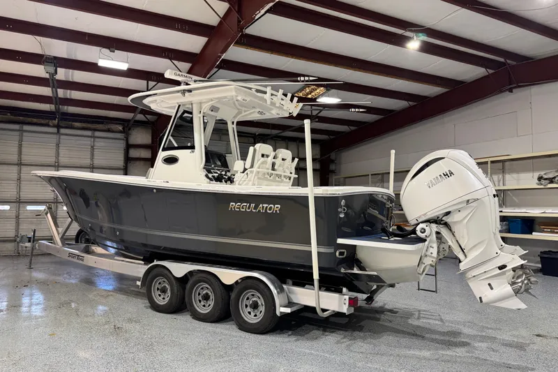  Yacht Photos Pics 2023 Regulator 28 boat with Yamaha engine in a garage setting.