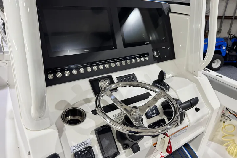  Yacht Photos Pics 2023 Regulator 28 boat dashboard with dual Garmin displays and stainless steel steering wheel.