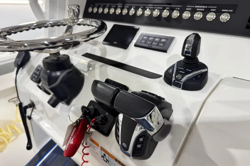  Yacht Photos Pics 2023 Regulator 28 boat dashboard with steering wheel and control panel.