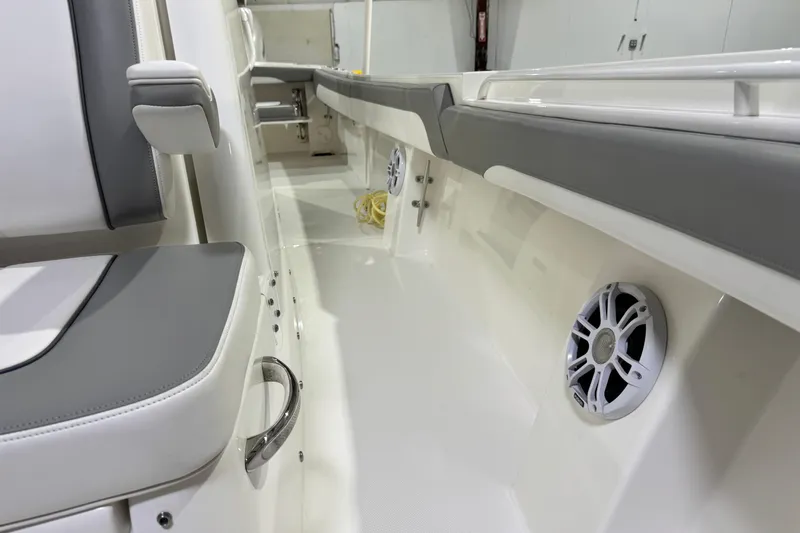  Yacht Photos Pics 2023 Regulator 28 boat interior with cushioned seating and built-in speaker system.