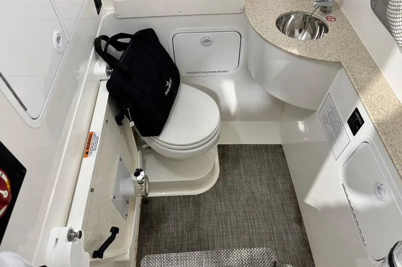  Yacht Photos Pics 2023 Regulator 28 boat interior with toilet, sink, and storage.