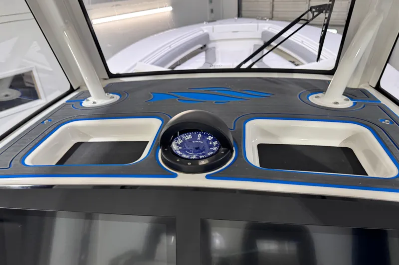  Yacht Photos Pics 2023 Regulator 28 boat dashboard with compass and storage compartments.