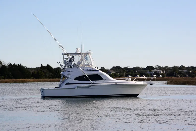 Lineage Yacht Photos Pics 2003 Bertram 390 Convertible yacht on calm water, side view.