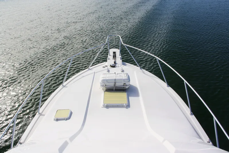 Lineage Yacht Photos Pics Bow view of 2003 Bertram 390 Convertible yacht on calm water.