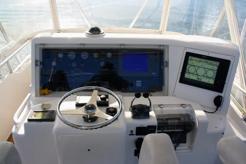 Lineage Yacht Photos Pics Helm of 2003 Bertram 390 Convertible with navigation instruments and steering wheel.