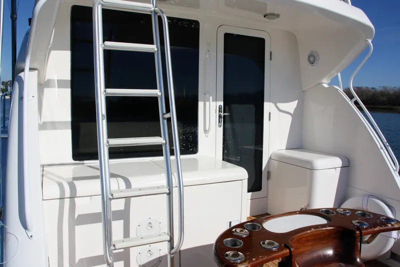Lineage Yacht Photos Pics 2003 Bertram 390 Convertible yacht deck with ladder and seating area.
