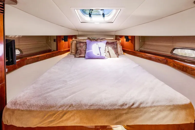  Yacht Photos Pics Luxurious bedroom interior of 2007 Sea Ray 48 Sundancer yacht with skylight and plush bedding.