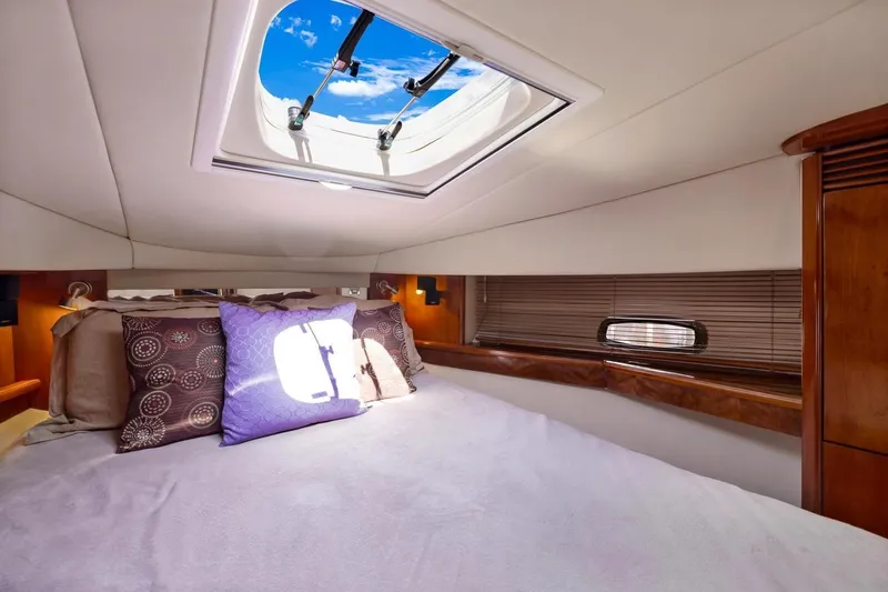  Yacht Photos Pics Luxurious cabin interior of 2007 Sea Ray 48 Sundancer yacht with skylight and plush bedding.