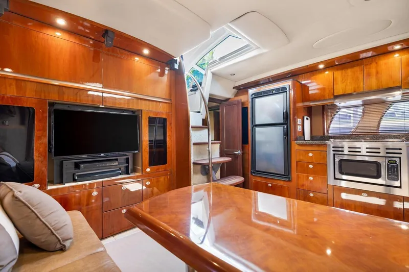  Yacht Photos Pics Luxurious interior of 2007 Sea Ray 48 Sundancer yacht with modern kitchen and entertainment area.