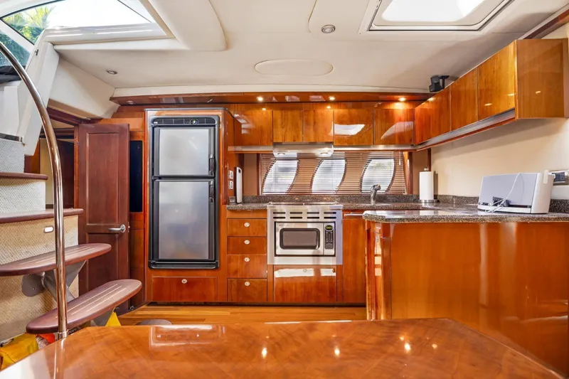  Yacht Photos Pics Luxurious 2007 Sea Ray 48 Sundancer yacht interior with modern kitchen and wooden cabinetry.
