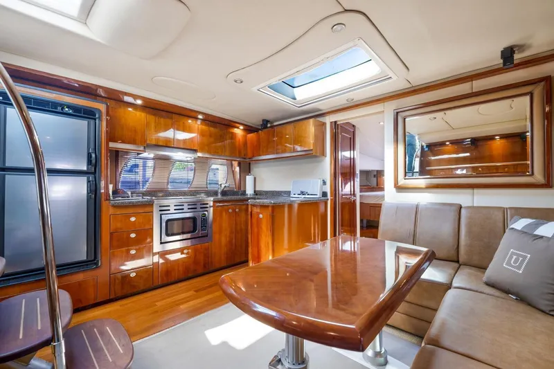  Yacht Photos Pics Luxurious interior of 2007 Sea Ray 48 Sundancer yacht with modern kitchen and seating area.
