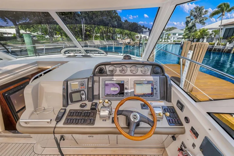  Yacht Photos Pics 2007 Sea Ray 48 Sundancer helm with advanced navigation controls and scenic waterfront view.