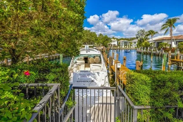  Yacht Photos Pics 2007 Sea Ray 48 Sundancer docked in a lush, tropical marina setting.