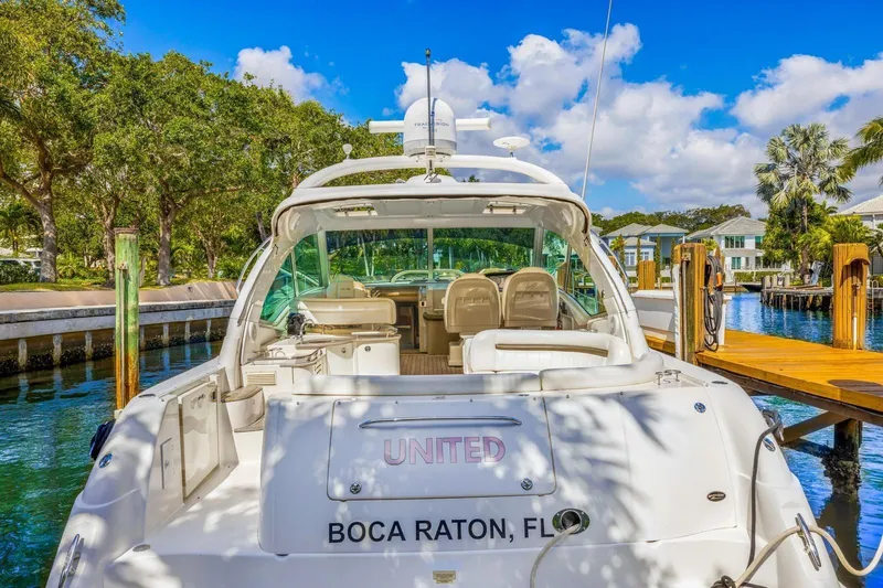  Yacht Photos Pics 2007 Sea Ray 48 Sundancer yacht docked in Boca Raton, Florida, surrounded by lush greenery.