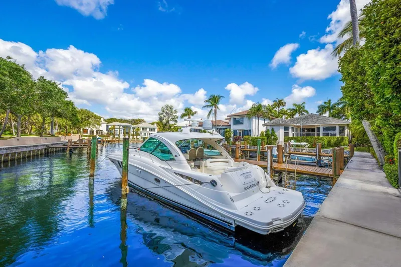  Yacht Photos Pics 2007 Sea Ray 48 Sundancer yacht docked in a scenic waterfront setting.