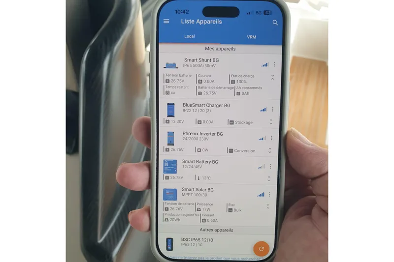 Point Break Yacht Photos Pics Smartphone displaying Bluegame BG 42 yacht's device management app interface, showing battery and solar data.