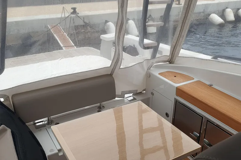 Point Break Yacht Photos Pics Interior of 2021 Bluegame BG 42 yacht with seating and wooden table.