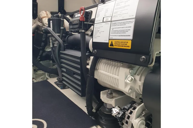 Point Break Yacht Photos Pics Engine compartment of 2021 Bluegame BG 42 yacht, showcasing mechanical components and warning labels.