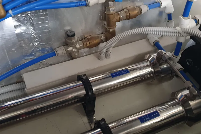 Point Break Yacht Photos Pics Engine room of 2021 Bluegame BG 42 yacht with stainless steel pipes and blue tubing.