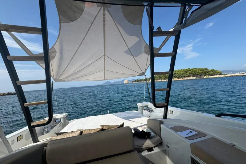 Point Break Yacht Photos Pics 2021 Bluegame BG 42 yacht with canopy, ocean view, and coastal landscape.