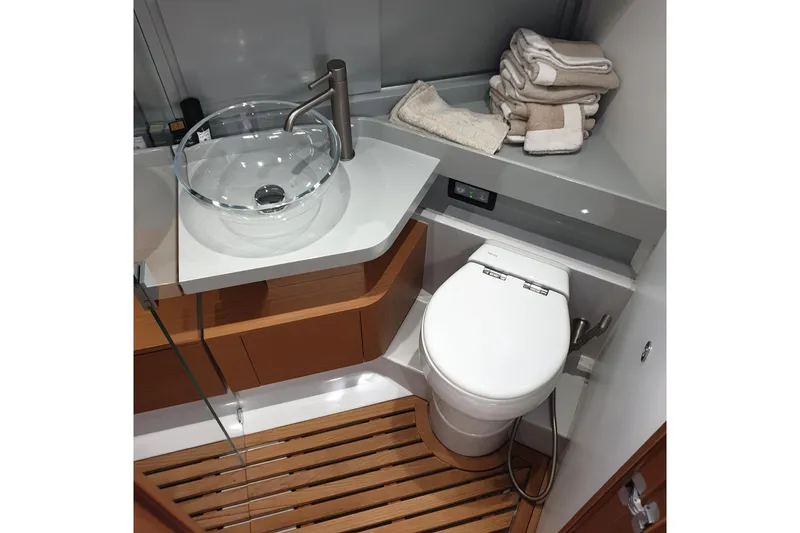 Point Break Yacht Photos Pics Luxurious bathroom in 2021 Bluegame BG 42 yacht with modern fixtures and wooden flooring.