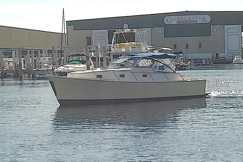 Dolce Far Niente Yacht Photos Pics 2004 Mainship 34 Pilot II yacht docked at marina, sunny day.