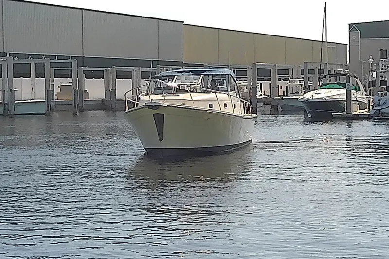 Dolce Far Niente Yacht Photos Pics 2004 Mainship 34 Pilot II yacht docked at marina, surrounded by water and other boats.