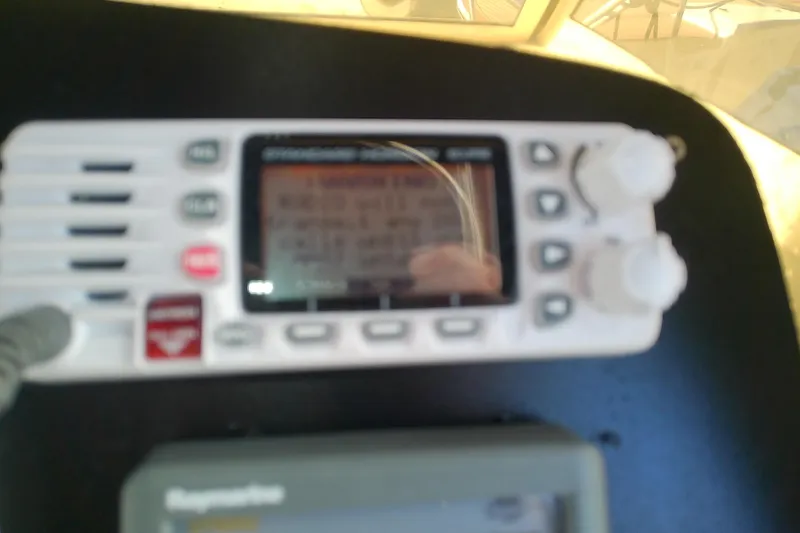 Dolce Far Niente Yacht Photos Pics Close-up of a marine radio on a 2004 Mainship 34 Pilot II boat.