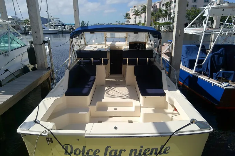 Dolce Far Niente Yacht Photos Pics 2004 Mainship 34 Pilot II boat docked, featuring spacious seating and canopy.