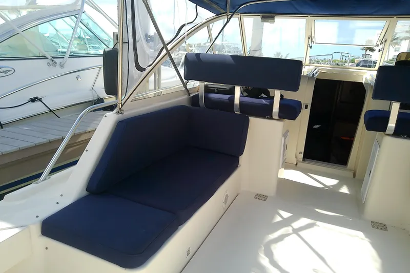 Dolce Far Niente Yacht Photos Pics 2004 Mainship 34 Pilot II boat interior with blue cushioned seating.