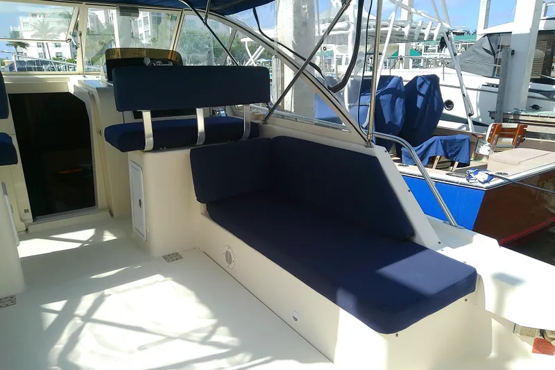 Dolce Far Niente Yacht Photos Pics 2004 Mainship 34 Pilot II boat interior with blue seating and open cockpit.