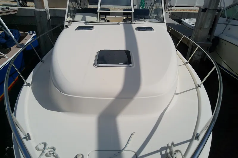 Dolce Far Niente Yacht Photos Pics 2004 Mainship 34 Pilot II boat docked, showcasing its sleek deck and railing.