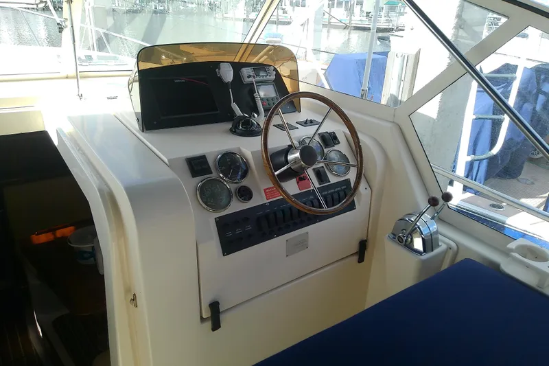 Dolce Far Niente Yacht Photos Pics 2004 Mainship 34 Pilot II helm with steering wheel and navigation controls.