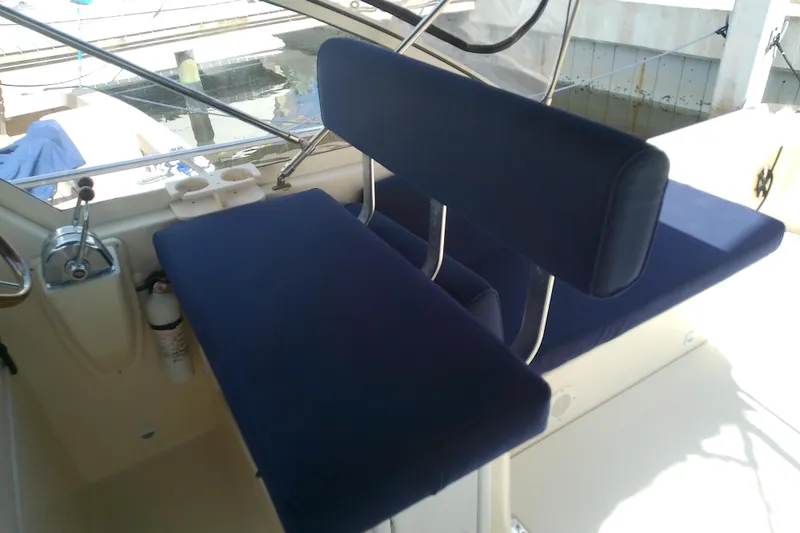 Dolce Far Niente Yacht Photos Pics 2004 Mainship 34 Pilot II boat interior with blue cushioned seating.