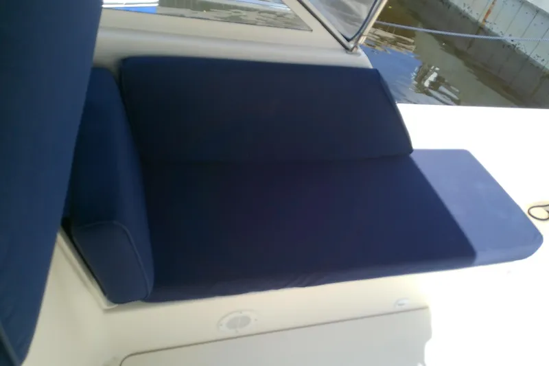 Dolce Far Niente Yacht Photos Pics Blue cushioned seating on 2004 Mainship 34 Pilot II boat deck.
