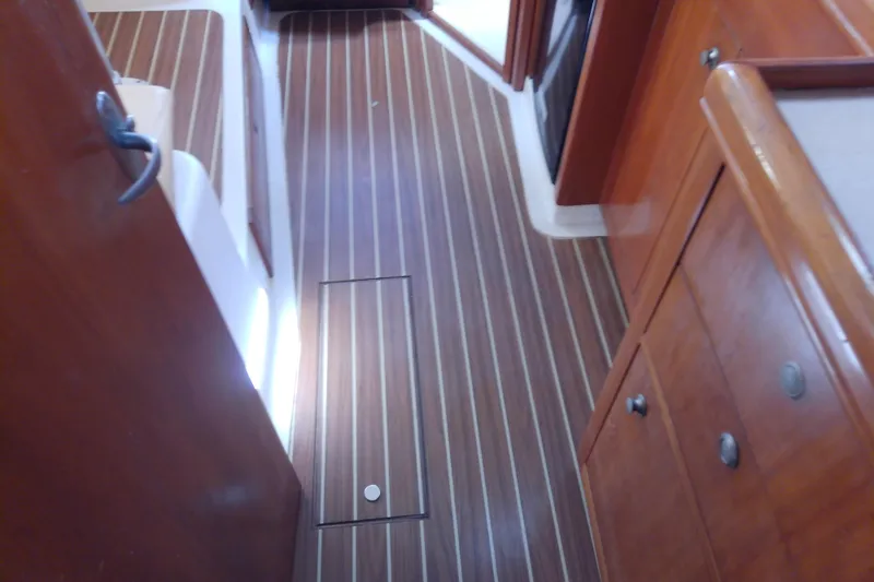 Dolce Far Niente Yacht Photos Pics 2004 Mainship 34 Pilot II interior with wood flooring and cabinetry.