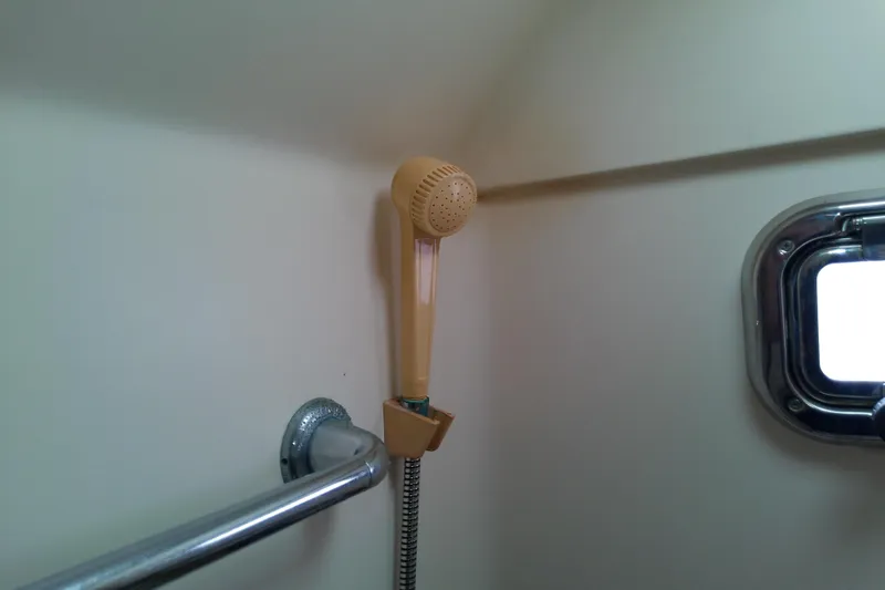 Dolce Far Niente Yacht Photos Pics Shower area in 2004 Mainship 34 Pilot II boat with porthole window.