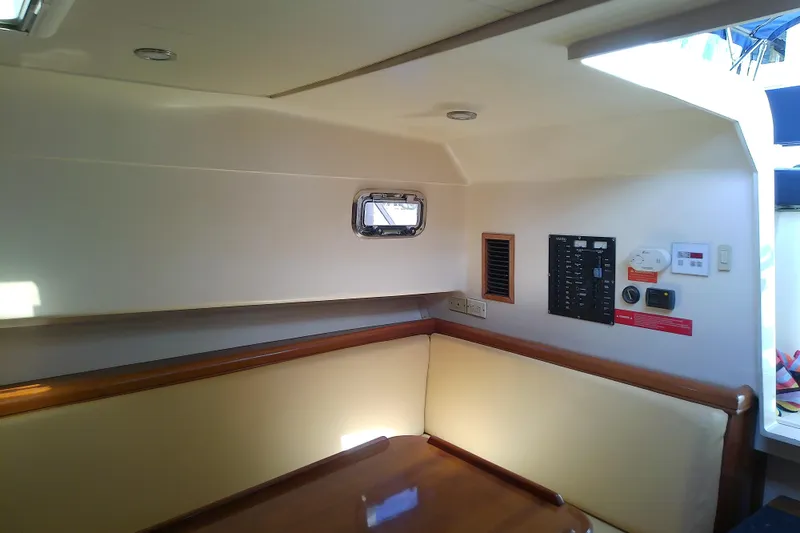 Dolce Far Niente Yacht Photos Pics 2004 Mainship 34 Pilot II cabin interior with seating and control panel.