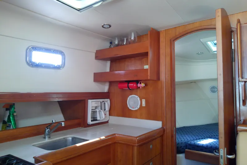 Dolce Far Niente Yacht Photos Pics 2004 Mainship 34 Pilot II interior with kitchenette and cozy cabin.