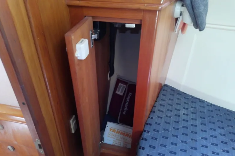 Dolce Far Niente Yacht Photos Pics Wooden cabinet with open door on 2004 Mainship 34 Pilot II boat interior.