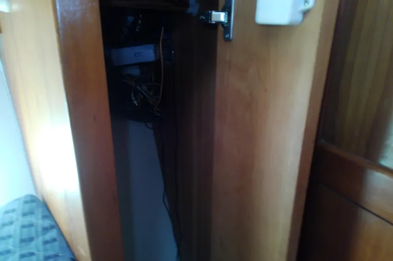 Dolce Far Niente Yacht Photos Pics Open wooden cabinet on 2004 Mainship 34 Pilot II boat, revealing interior wiring.