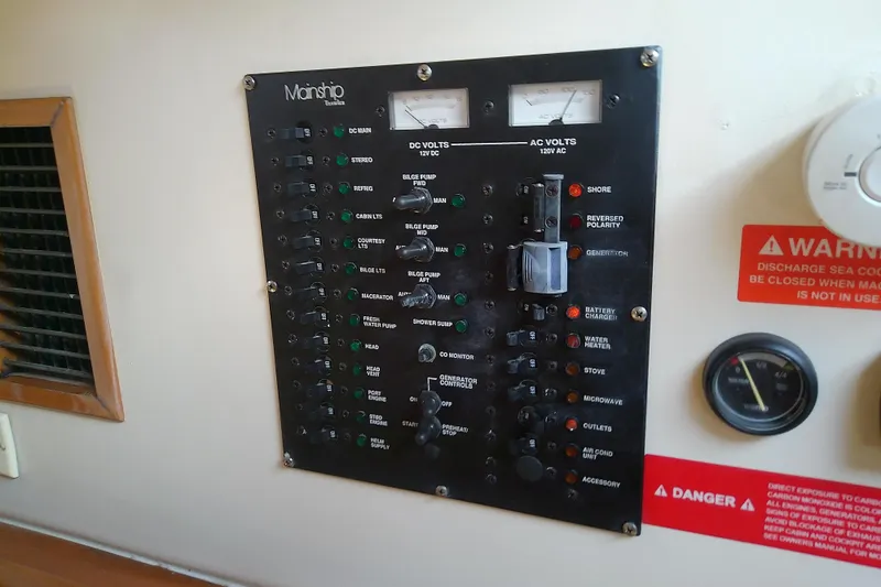 Dolce Far Niente Yacht Photos Pics Electrical control panel on a 2004 Mainship 34 Pilot II boat, featuring various switches and gauges.