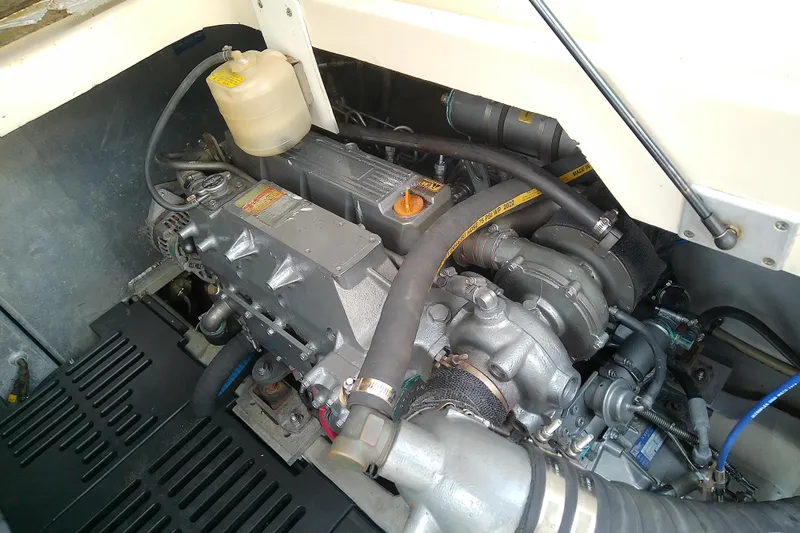 Dolce Far Niente Yacht Photos Pics Engine compartment of a 2004 Mainship 34 Pilot II boat, showcasing mechanical components.