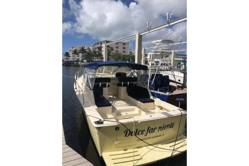 Dolce Far Niente Yacht Photos Pics 2004 Mainship 34 Pilot II docked, featuring "Dolce far niente" on the stern.